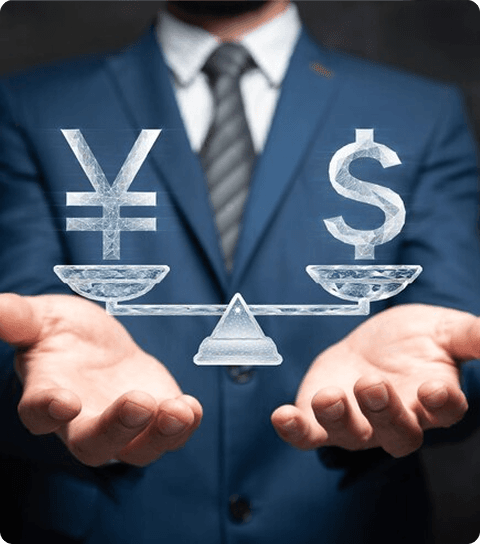 Businessman balancing Yen and Dollar currency symbols