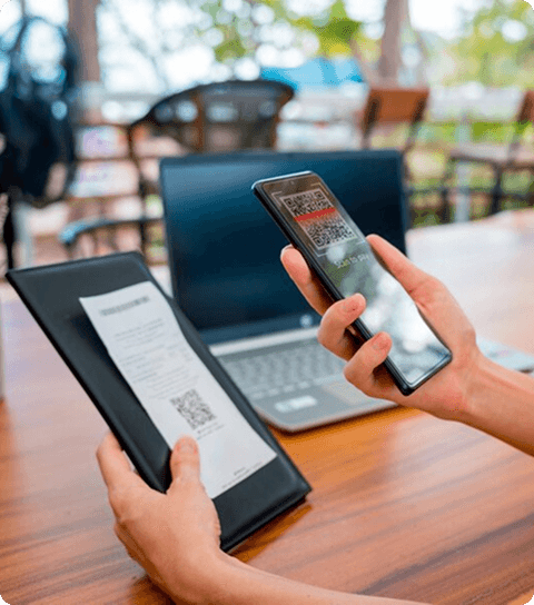 Hand holding mobile device to photograph receipt