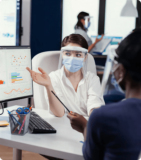 Dentist and patient discussing metrics on a screen