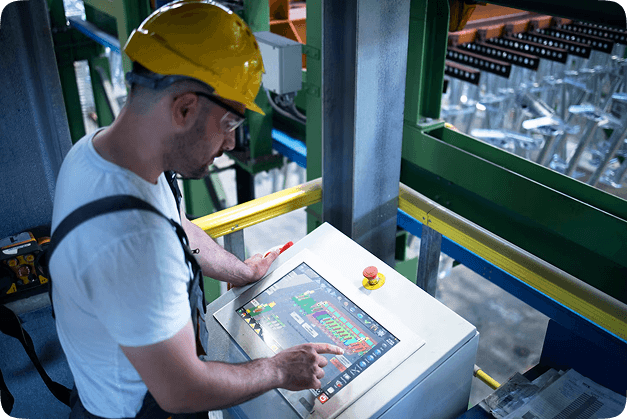 Operator using a touchscreen control panel in a manufacturing facility