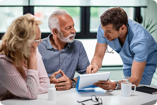 Doctor discussing treatment options and payment plans with a senior couple