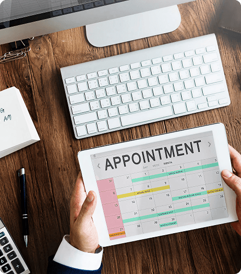 Digital tablet showing appointment schedule with dental tools