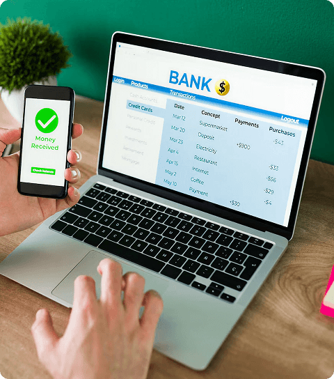 Laptop screen showing bank dashboard with successful payment notification