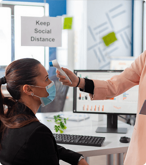 Clinic staff checking patient temperature with a thermometer